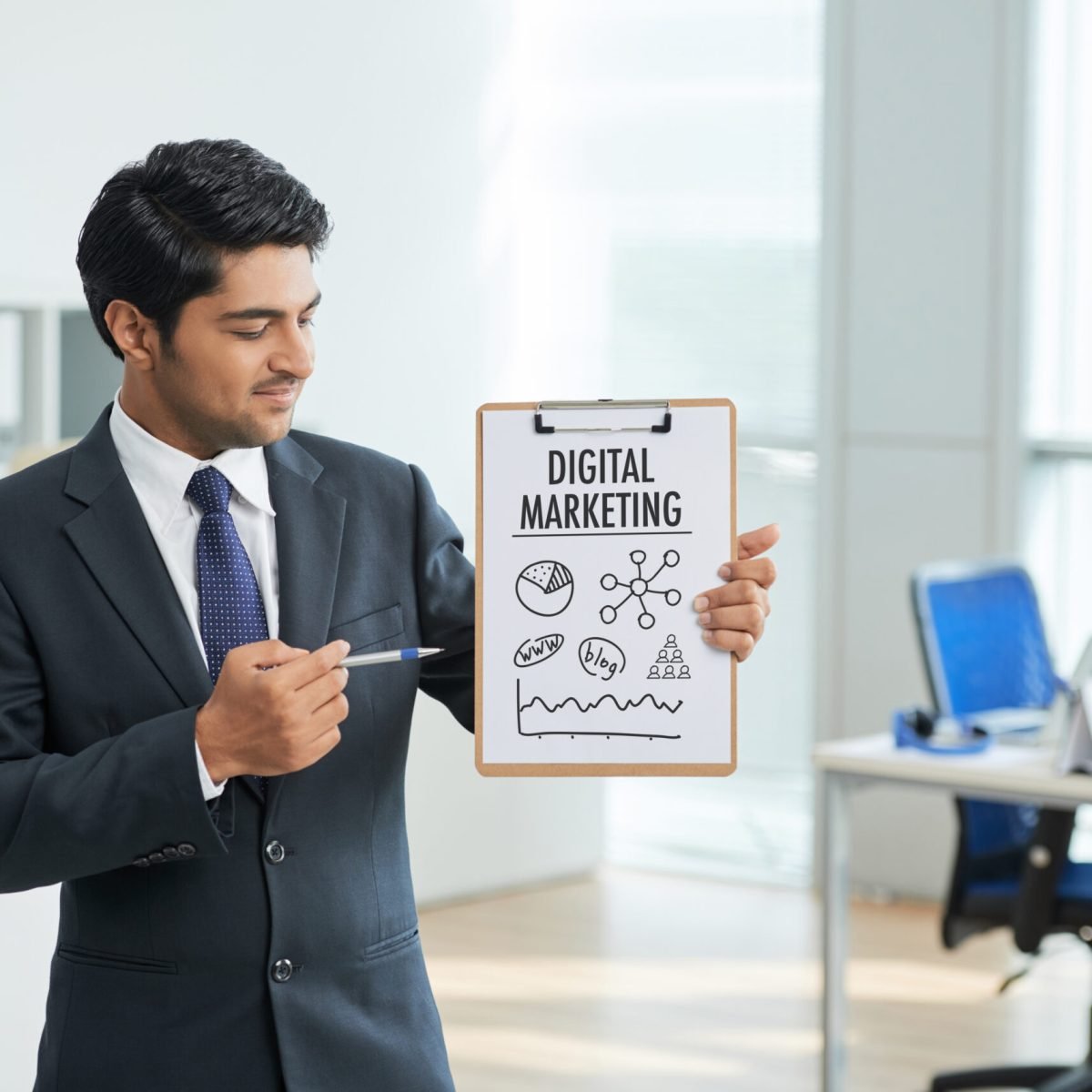 man-suit-standing-office-with-clipboard-pointing-poster-with-words